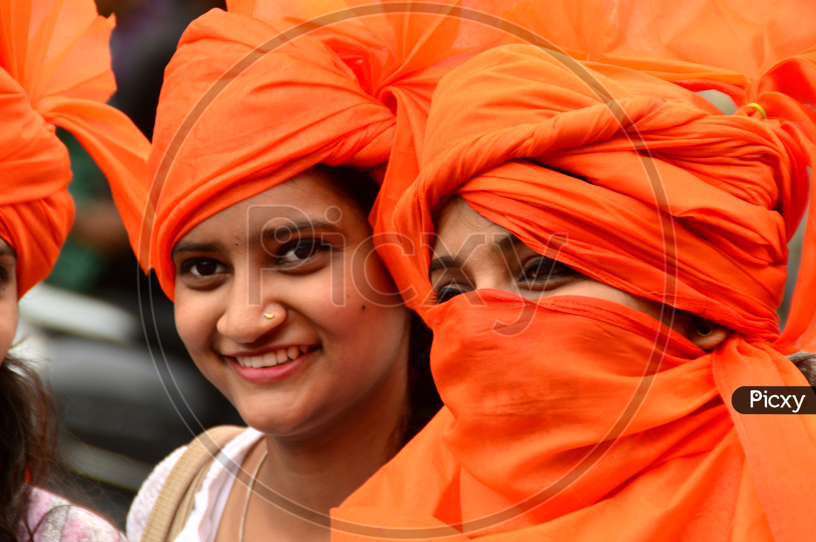 Image of Indian Young Girls Wearing Saffron Turbans And White Clothes