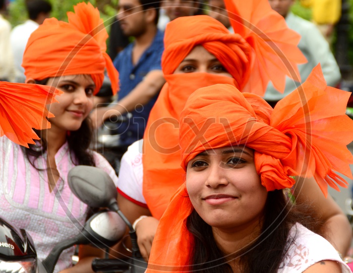 Indian Young Girls Wearing Saffron Turbans And White Clothes In Independence Day Celebrations