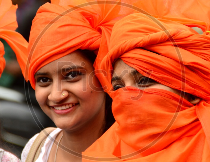 image-of-indian-young-girls-wearing-saffron-turbans-and-white-clothes