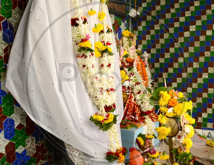 Indian Hindu Snake God statue decorated with flowers