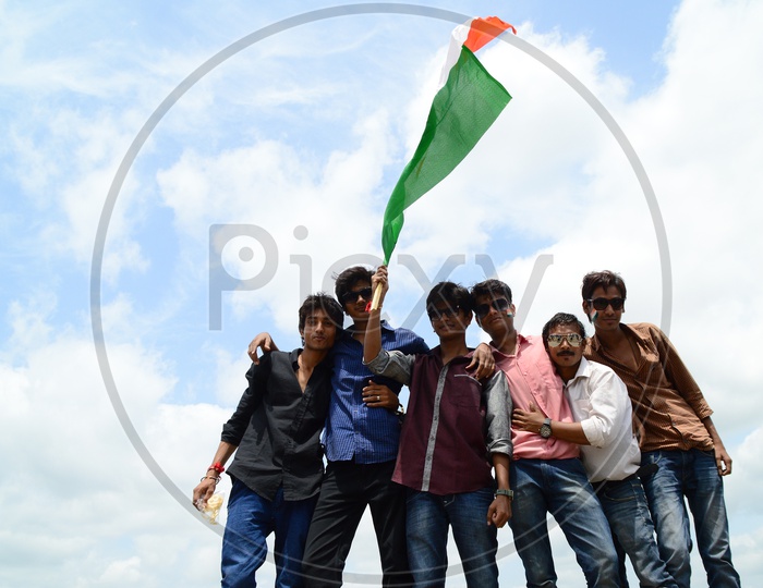 Young Indian People Waving  Indian National Flag ( Tri-Color ) Celebrating Independence Day