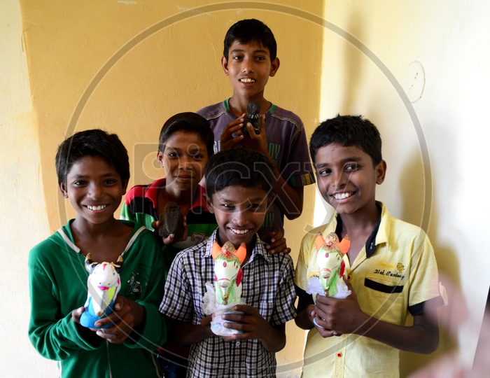 Indian Children Holding Holy Cow Idols In Hands