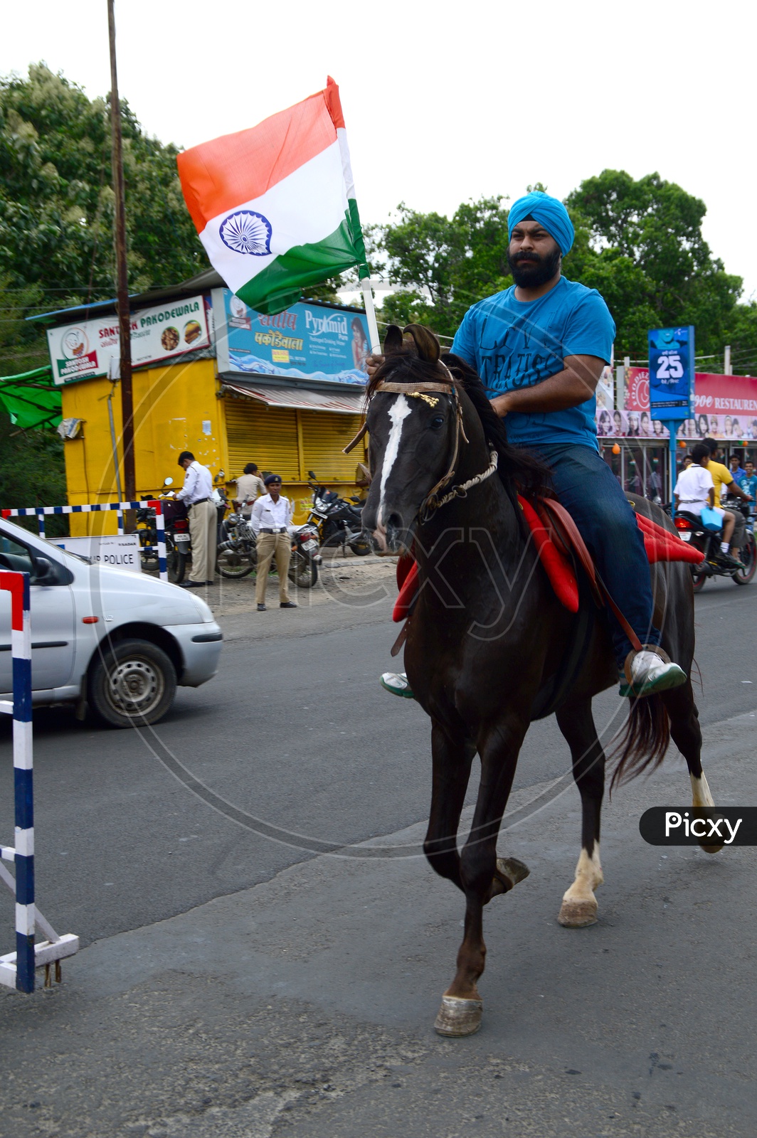 A Sikh Man With Indian National Flag Riding a Horse