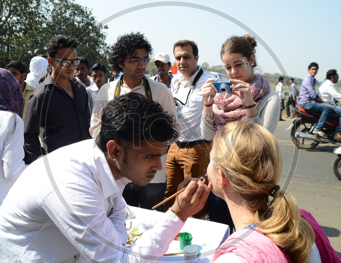 Indian Young People Pasting Indian National Tri-Colors On the Cheek To a Foreign Lady Celebrating Independence Day