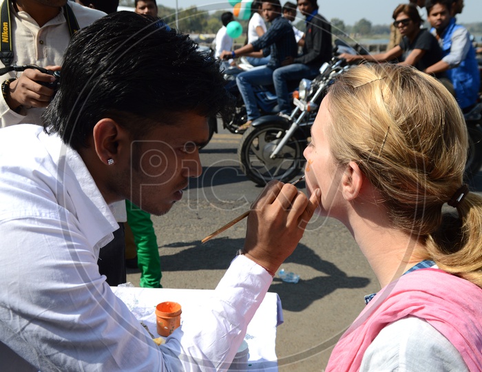 Indian Young People Pasting Indian National Tri-Colors On the Cheek To a Foreign Lady Celebrating Independence Day