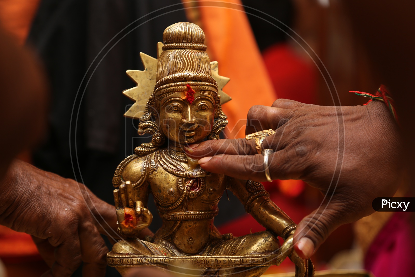 Hindu God Sitting in Front of Candles and Lights