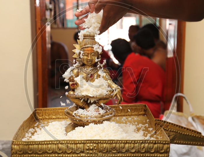 Rice abhishekam is the showering of rice on  Lord Ayyappa