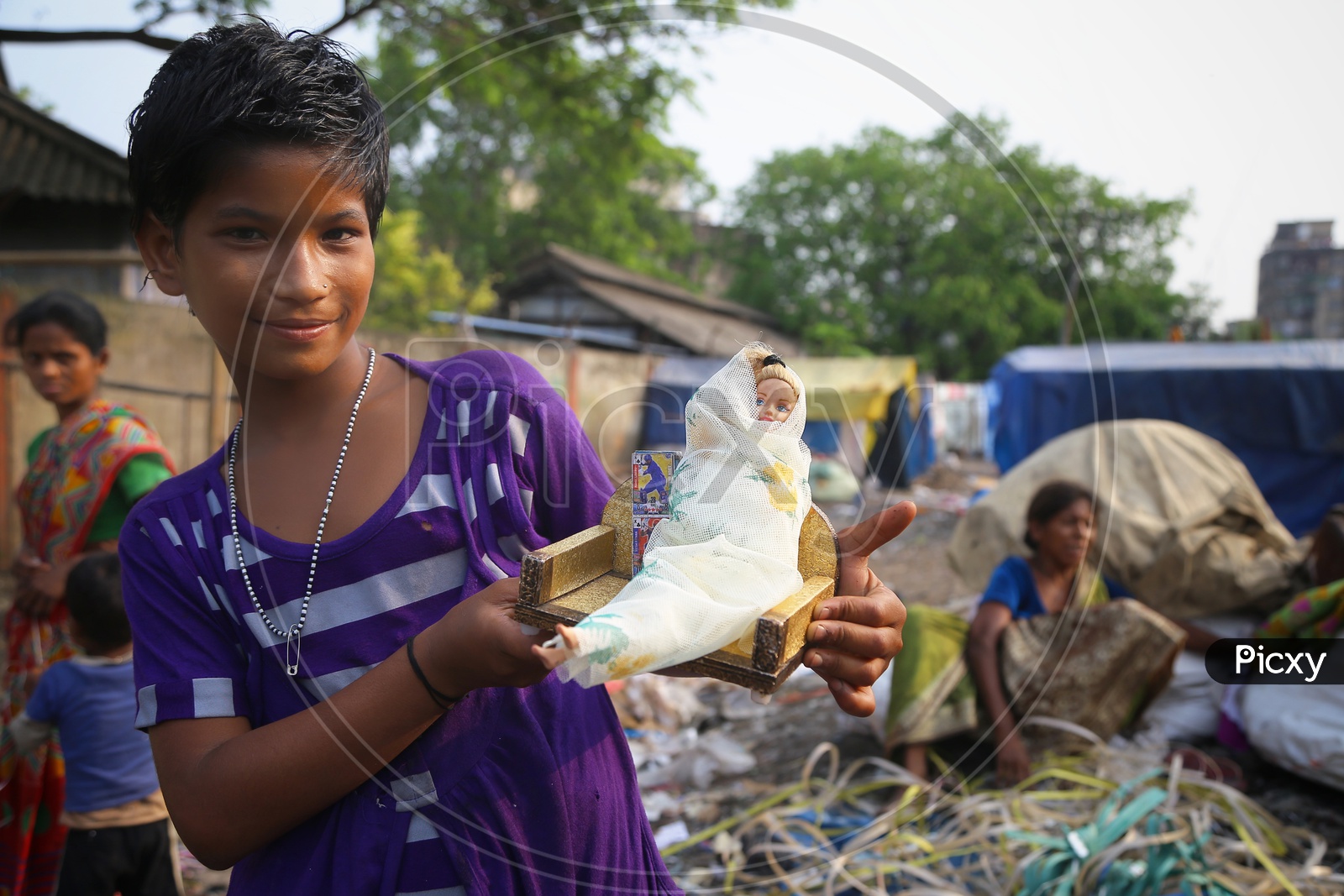 An Indian Slum Girl or  Children Holding a  Doll  In Hand