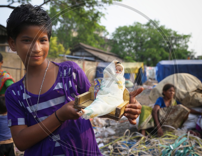 An Indian Slum Girl or  Children Holding a  Doll  In Hand