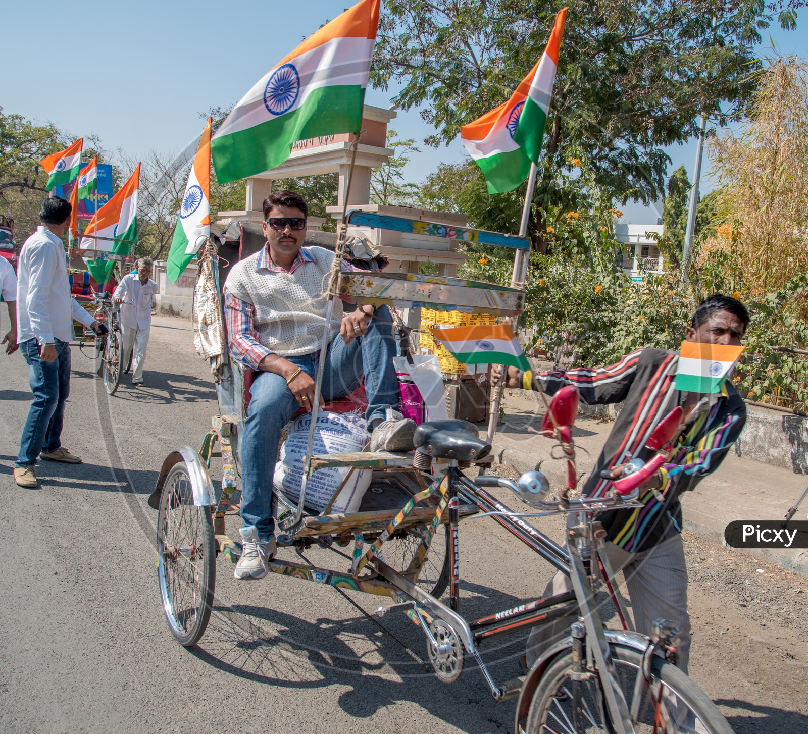 A Rickshaw Puller With Indian National Flags Tagged To His Rickshaw on Republic Day