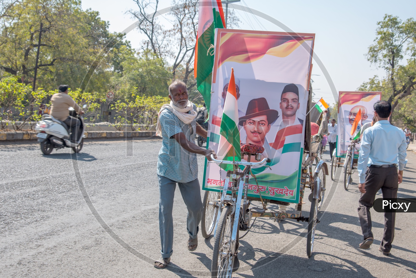 Rickshaw Pullers Carrying The Photo Frames Of Indian Freedom Fighters In a Road Rally  On  the Occasion Of Republic Day