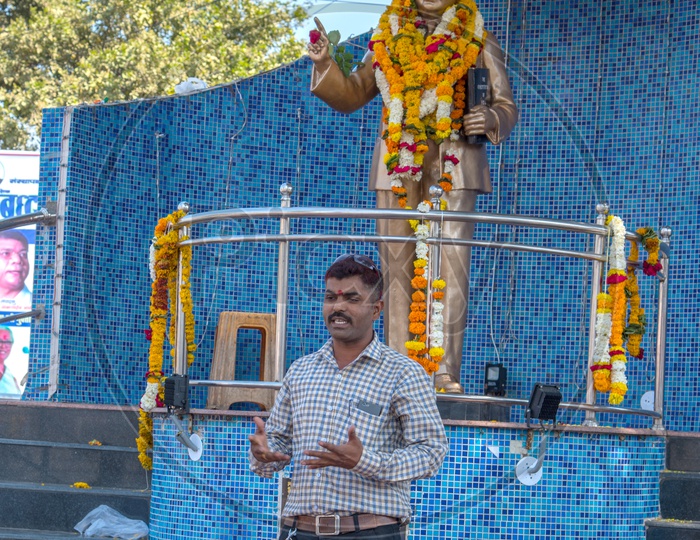 An Indian Man  Speaking at Dr. B R Ambedkar Statue
