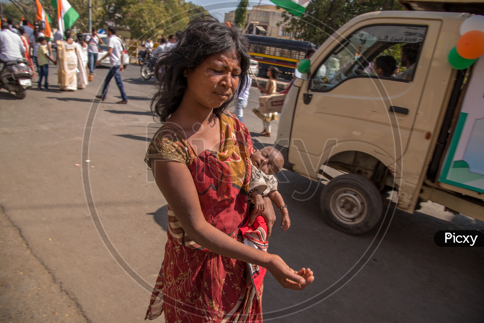A Woman Beggar Along With a Child in her Arms  On the Streets Of India