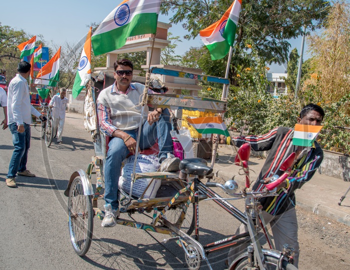 A Rickshaw Puller With Indian National Flags Tagged To His Rickshaw on Republic Day