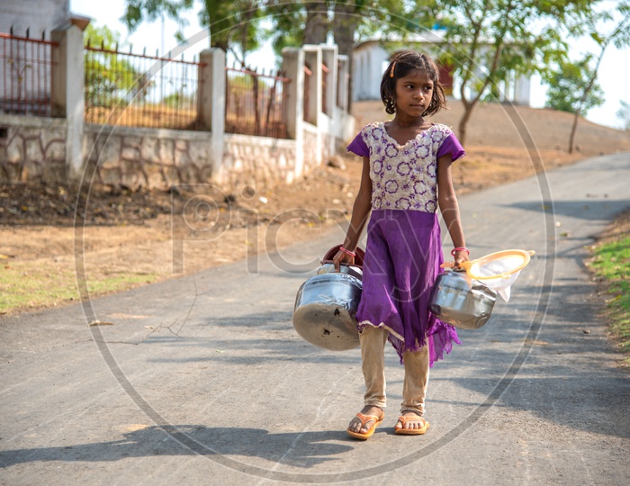 A Small Girl Carrying Vessels For Collecting Water in a Drought Effected Village