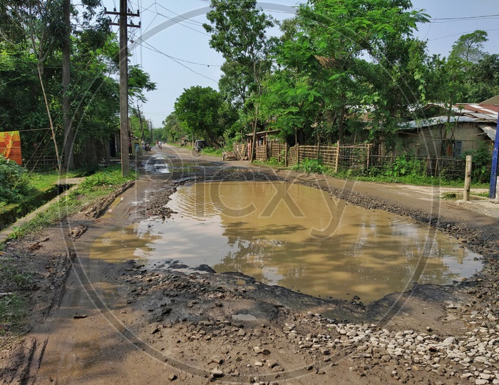 Potholes  Filled With Rain Water  on Rural Village Roads  in Rainy Season