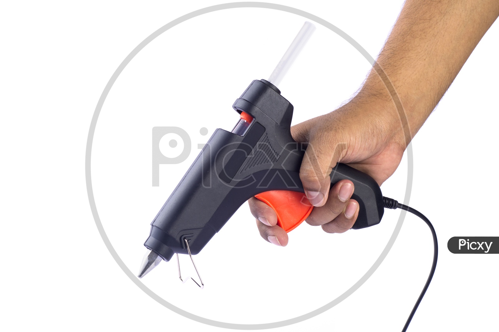 A Man Holding a Hot Glue Gun In Hand Over a White Isolated Background