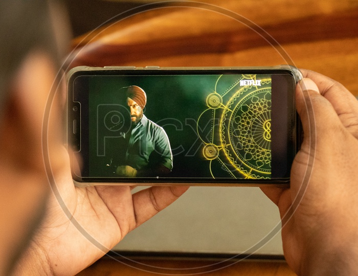 Indian Young Man Watching Sacred Games 2  Trailer In  Smart Phone