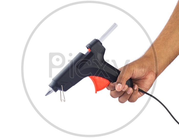 A Man Holding  a Hot Glue Gun In Hand On an Isolated White Background