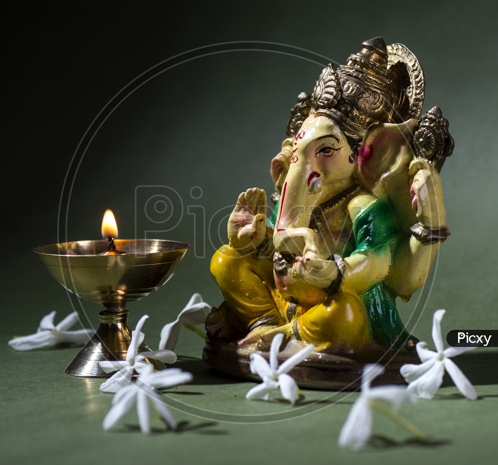 Indian Hindu God , Lord Ganesh Idol With a Dia on an Isolated  Black Background