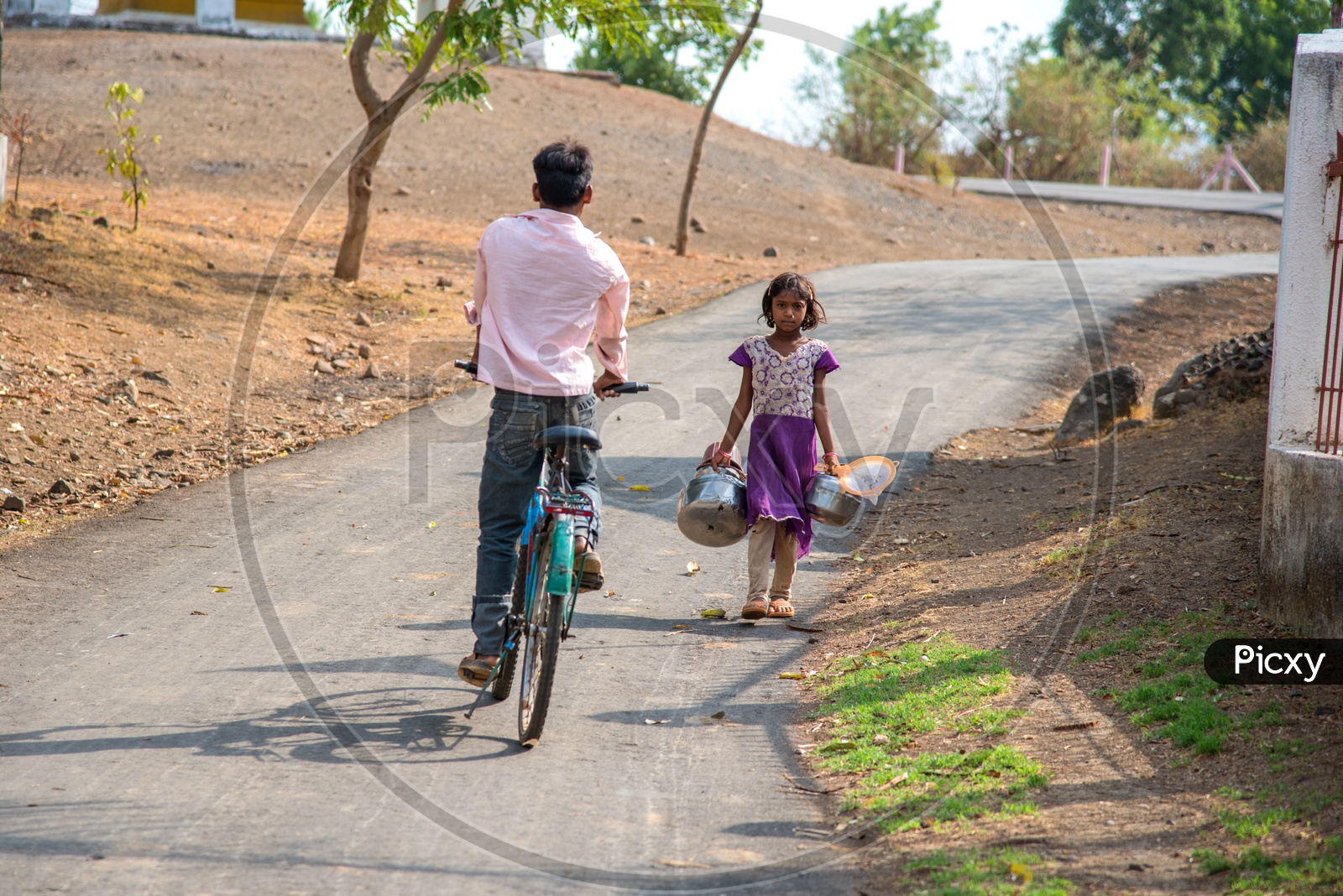 A Small Girl Carrying Vessels For Collecting Water in a Drought Effected Village