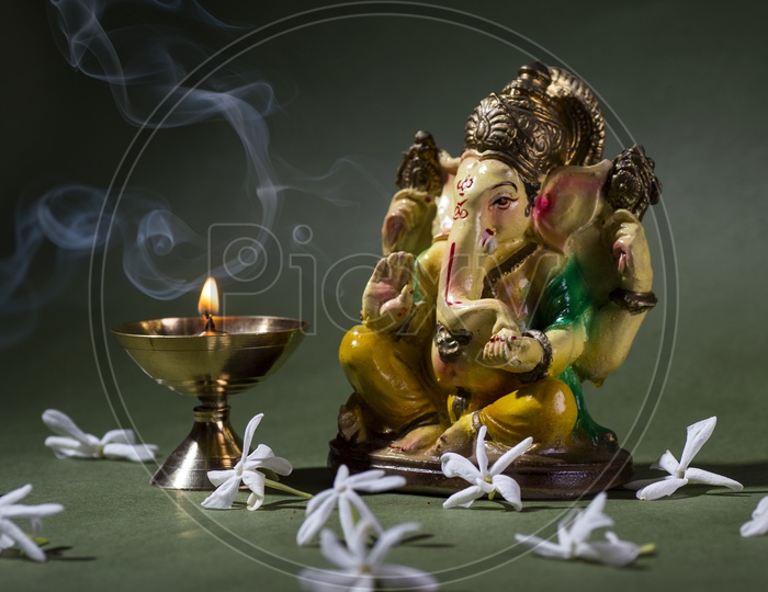 Indian Hindu God , Lord Ganesh Idol With a Dia on an Isolated  Black Background