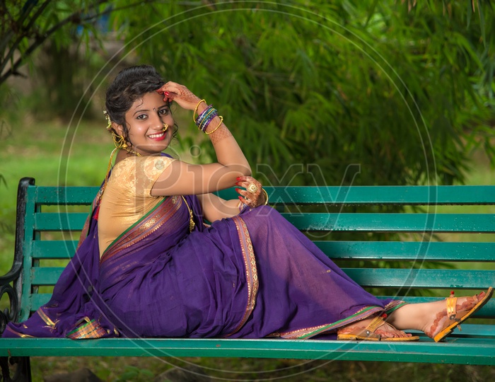 Indian traditional Beautiful Woman Wearing an traditional Saree And Posing On The Outdoor  With a Smile Face