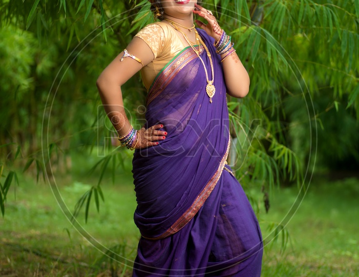 Image of Indian traditional Beautiful Woman Wearing an traditional Saree  And Posing On The Outdoor With a Smile Face-AC520820-Picxy