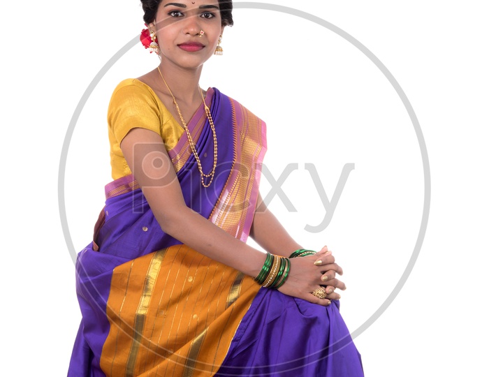 Beautiful Indian young girl posing in traditional Indian saree on white background.