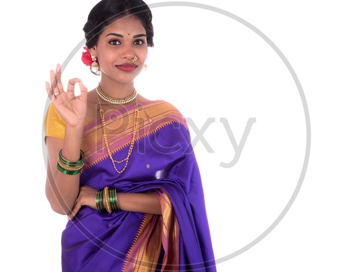 A Young Indian Traditional Girl Wearing an Sari And With an Expression Posing On an isolated White Background