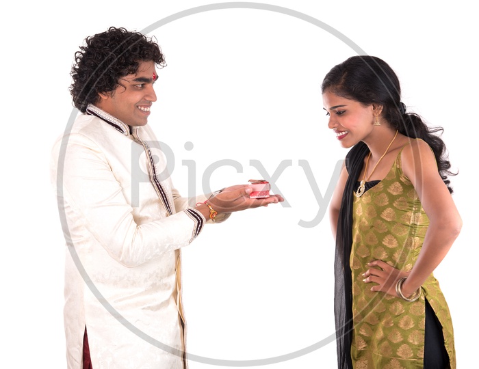 Brother Gifting His Sister With A Gift Box On The Occasion Of Rakhi Festival