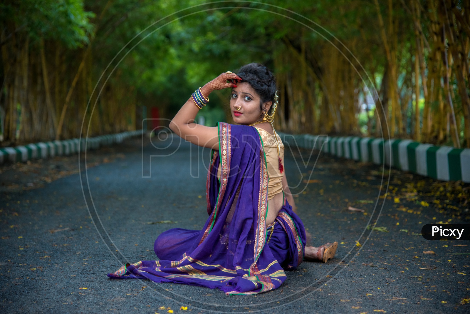 Beautiful Indian girl or women or kid saying namaste. greeting guests with  both hands together , wearing