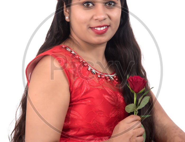 Portrait of a Beautiful Young Woman Standing And Posing With  A Red Rose In Hand On an Isolated white Background