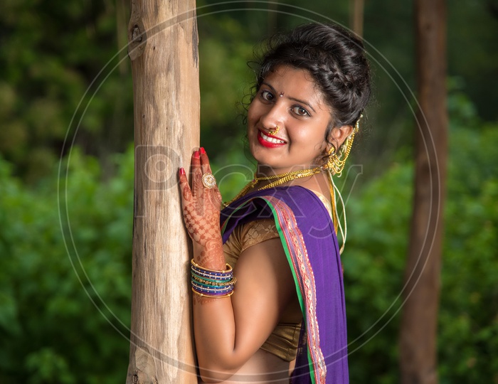 Image of Indian traditional Beautiful Woman Wearing an traditional Saree  And Posing On The Outdoor With a Smile Face-DK767961-Picxy