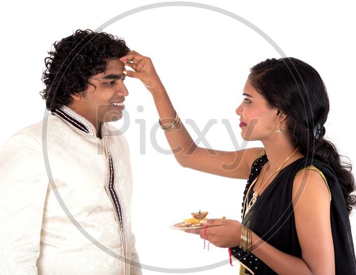 An Indian Sister Tying Rakhi To Her Brother On The Occasion Of Rakhi Festival