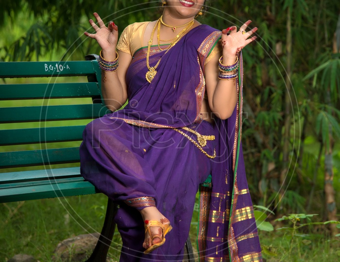Image of Indian traditional Beautiful Woman Wearing an traditional Saree  And Posing On The Outdoor With a Smile Face-TL775956-Picxy