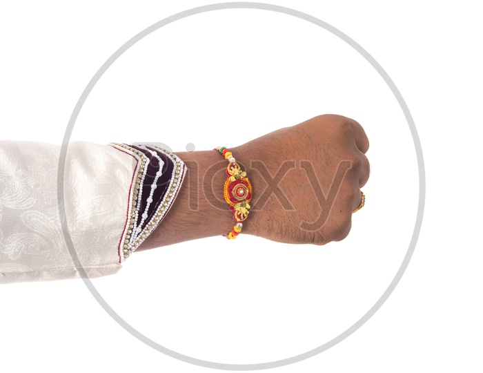 An Indian Man Or Brother Hand Tied With Elegant Rakhi  on The Rakhi Festival Occasion  On an Isolatted White Background