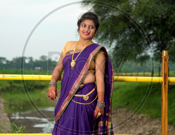 Indian traditional Beautiful Woman Wearing an traditional Saree And Posing On The Outdoor  With a Smile Face