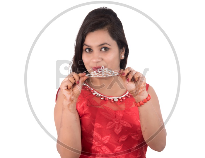 Portrait of a Beautiful Young Woman Standing And Posing With  A Queen Crown  On an Isolated white Background