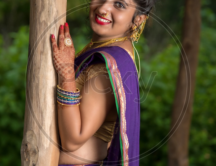 Image of Indian traditional Beautiful Woman Wearing an traditional Saree  And Posing On The Outdoor With a Smile Face-EL256597-Picxy