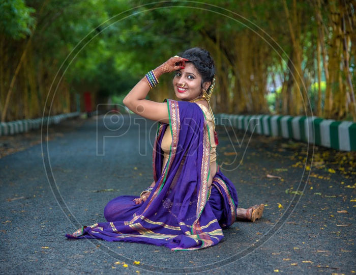 Image of Indian traditional Beautiful Woman Wearing an traditional Saree  And Posing On The Outdoor With a Smile Face-XM041963-Picxy