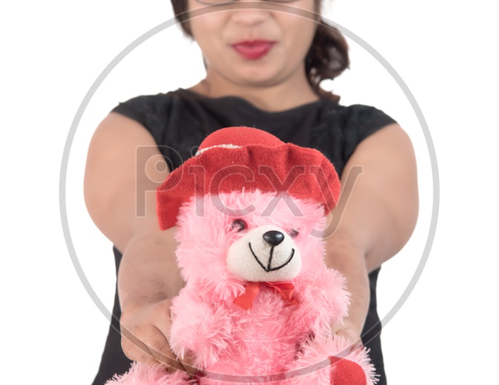 A Beautiful Young Woman Holding a Teddy Bear in hand and Playing On an Isolated  White Background