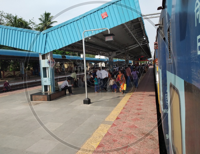 Passengers Boarding Train in a Railway Station Platform