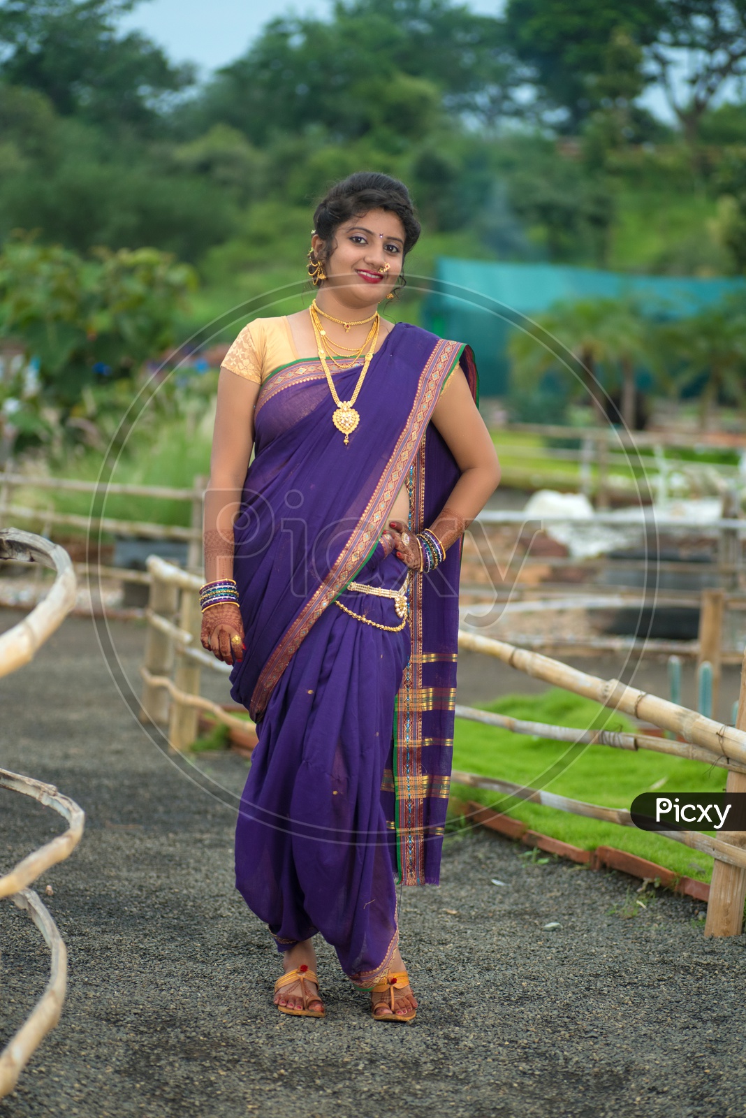 Indian traditional Beautiful Woman Wearing an traditional Saree And Posing On The Outdoor  With a Smile Face