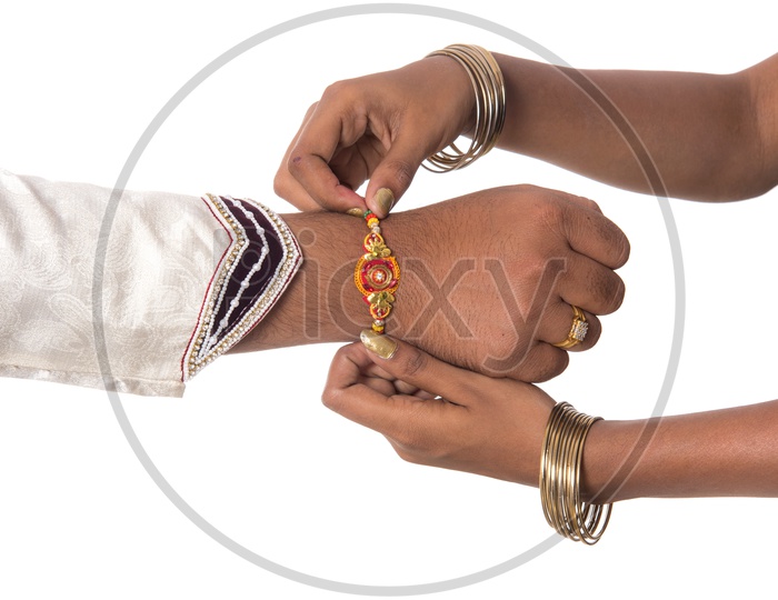 An Indian Man Or Brother Hand Tied With Elegant Rakhi  on The Rakhi Festival Occasion  On an Isolatted White Background