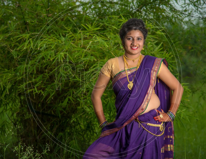 Indian traditional Beautiful Woman Wearing an traditional Saree And Posing On The Outdoor  With a Smile Face