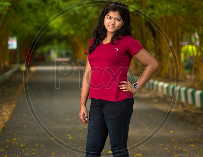 A beautiful young girl poses for a fashion style portrait outdoors at a  park with natural lighting Stock Photo - Alamy