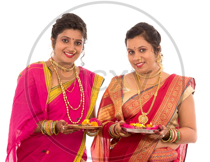 Indian Traditional Marathi Woman or Sisters Holding Pooja Plate And Performing Pooja On an Isolated White Background