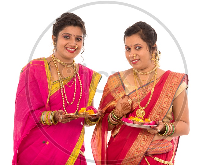 Indian Traditional Marathi Woman or Sisters Holding Pooja Plate And Performing Pooja On an Isolated White Background