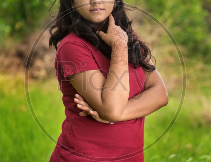 Portrait Of a Young Indian Beautiful Woman Posing In Outdoor Or In a Park Background